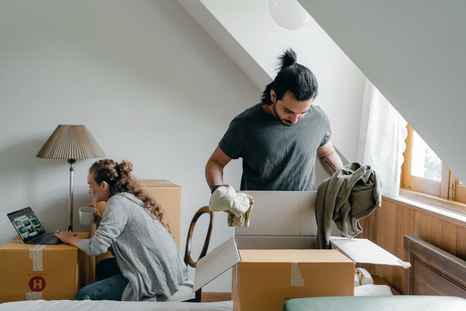 A family happily unpacking boxes in their new living room