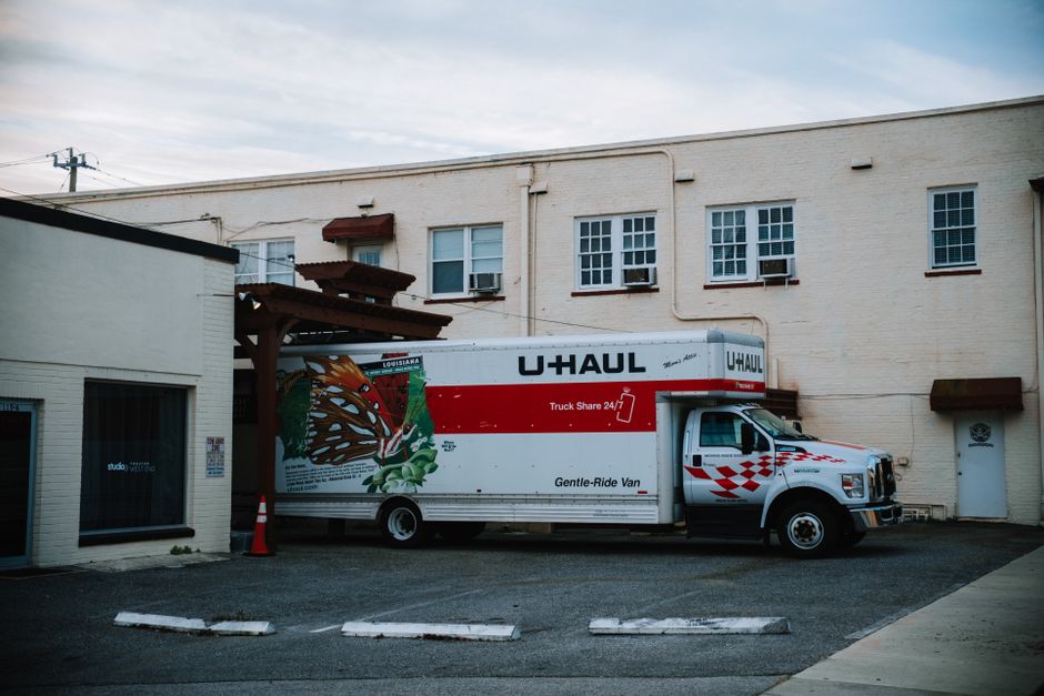 Moving truck parked outside a residential home ready for loading